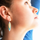 Unusual patina drop silver earrings on model