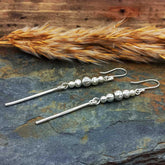 Handmade long unusual silver ball earrings