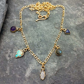 Semi-precious stone pendant on a brass chain.