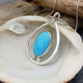 Silver pendant with Larimar on a shell