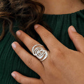 Wide silver ring with a sculpted, layered spiral design, handmade and unusual ring.