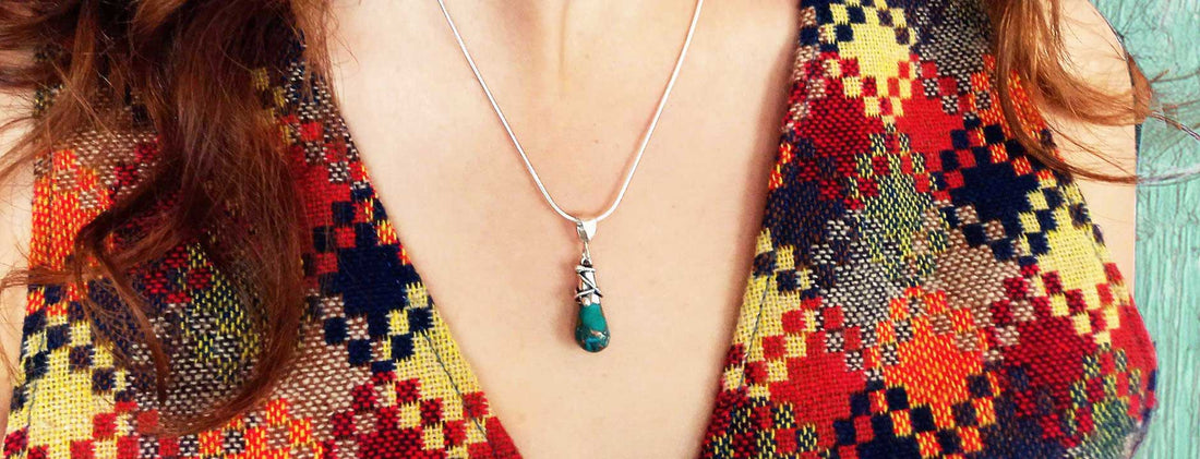 Turquoise silver pendant being  by model