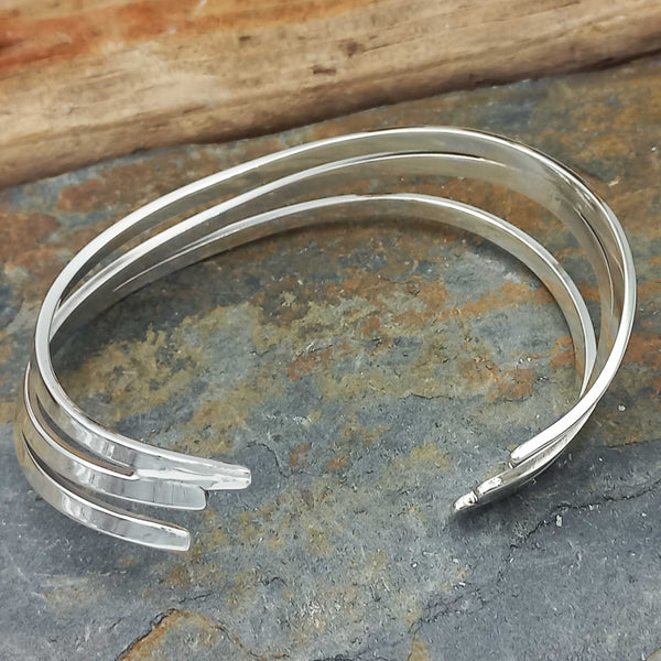 Silver bangle on a textured stone surface