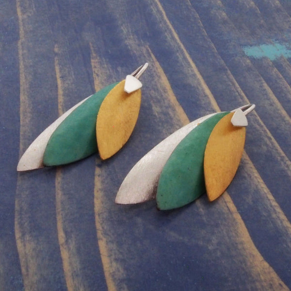 Layered different coloured earrings