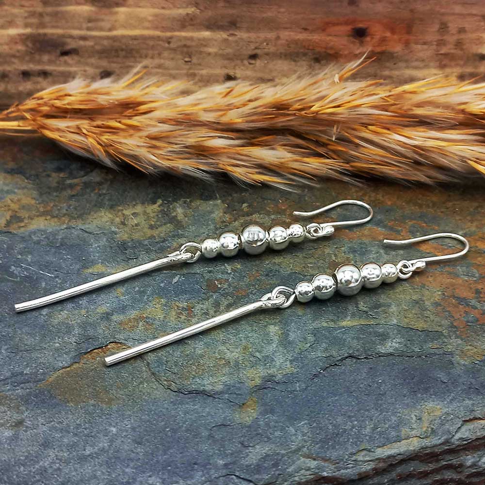 Handmade long unusual silver ball earrings