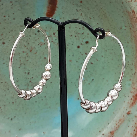 Silver hoop earrings with beads