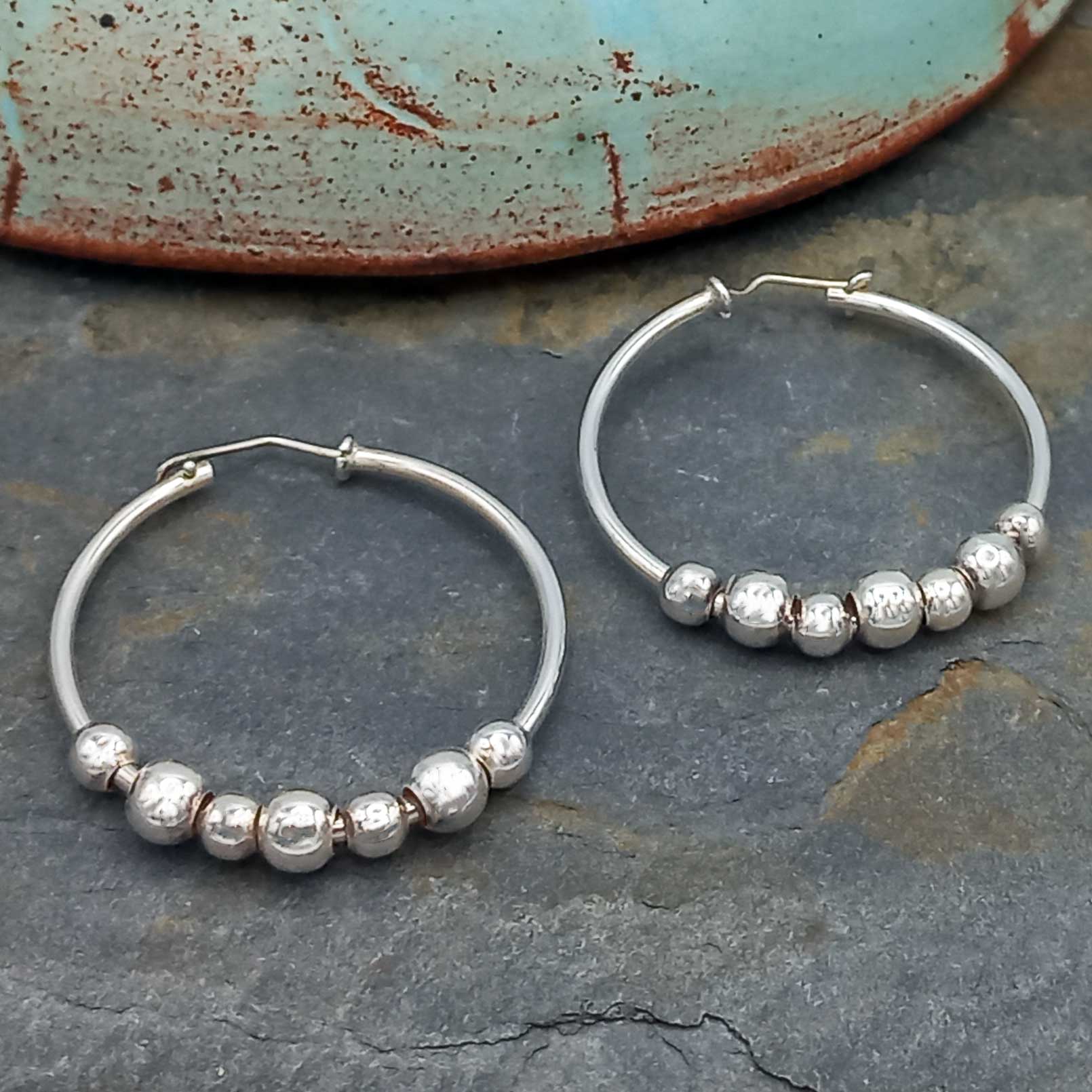 Unusual silver hoops with balls