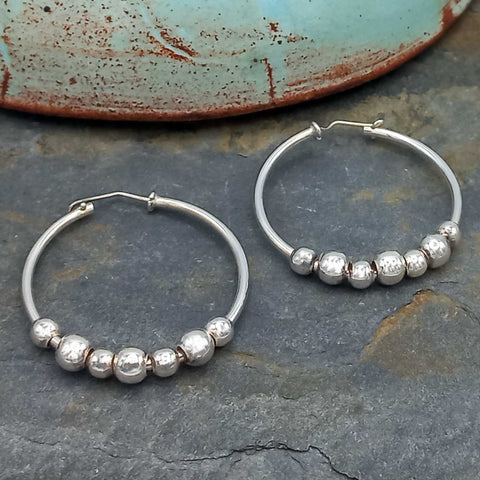 Unusual silver hoops with balls