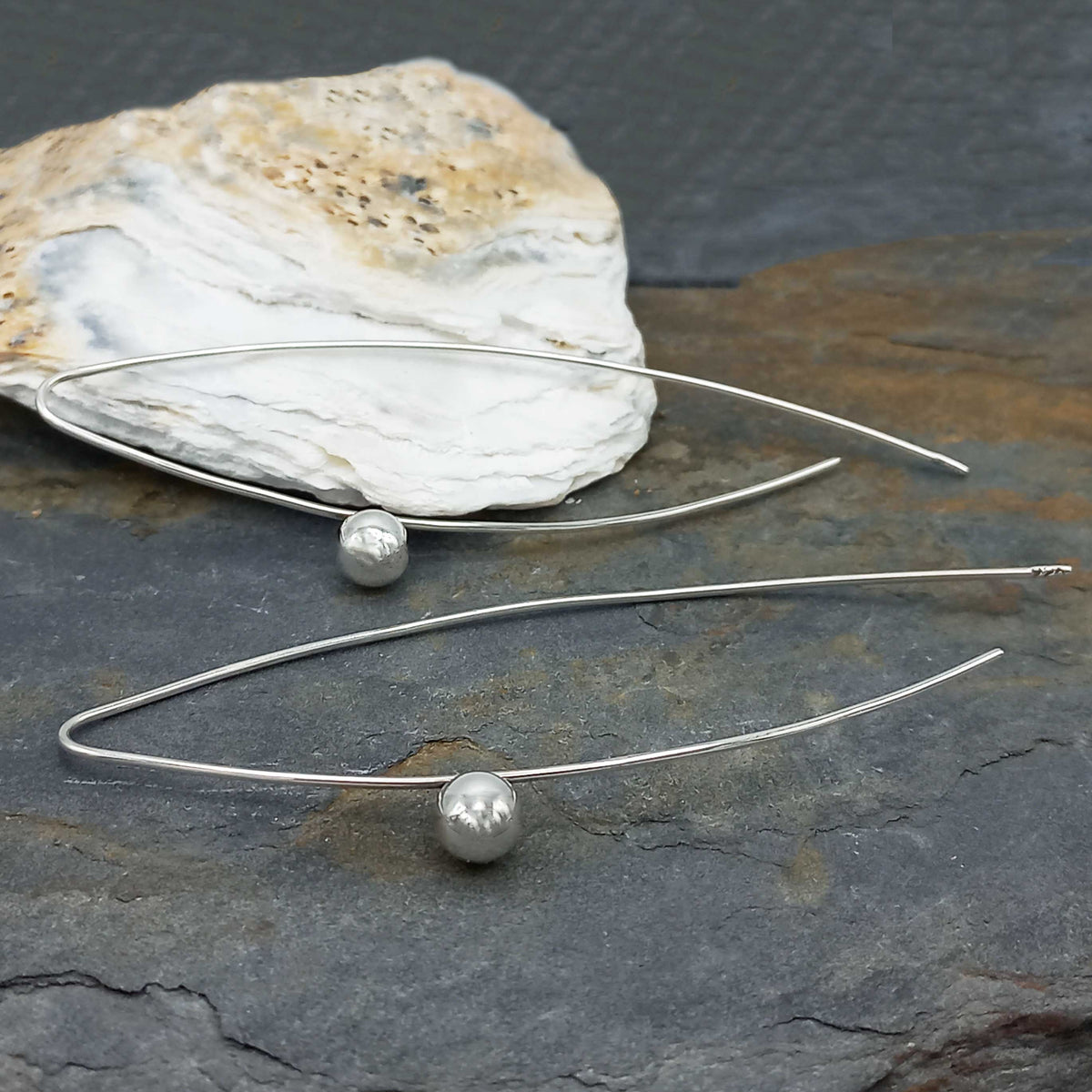 Dangly long silver ball earrings Main image