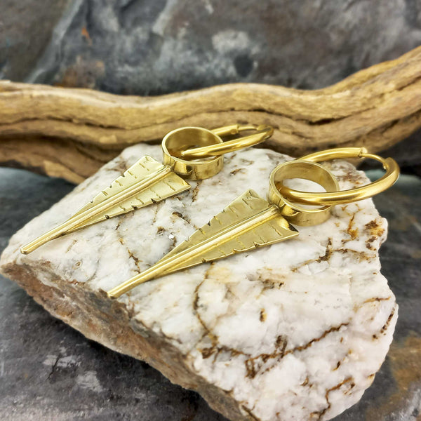 Golden arrow suspended from hoop brass statement earrings