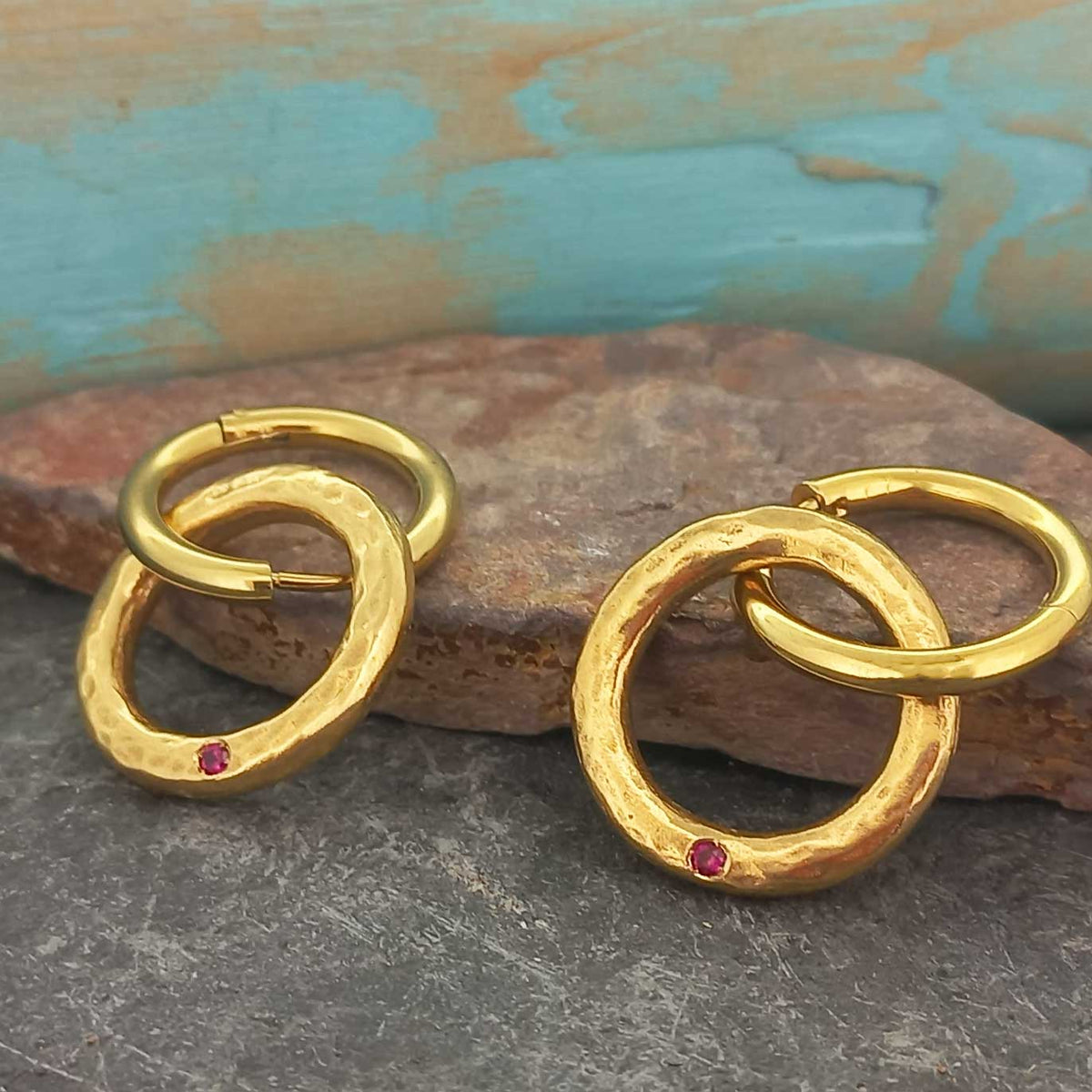 Gold-plated brass rings of fire with red glass cabochon