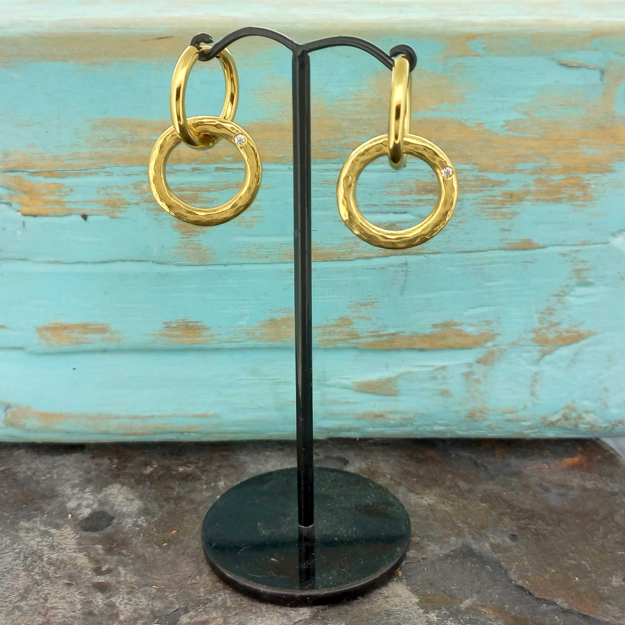White glass stone set in gold-plated circle unusual earrings
