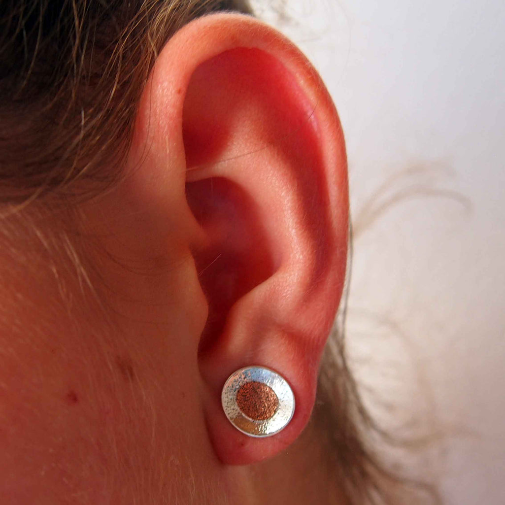 Textured silver circle with copper studs
