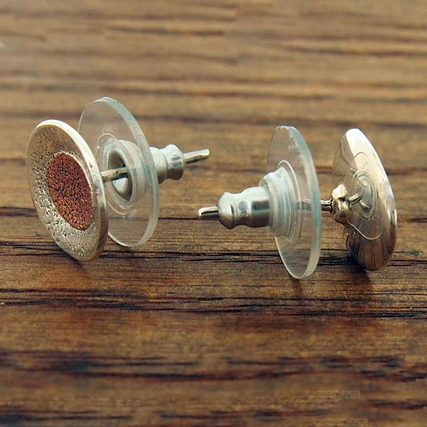 Pair of stud earrings on a wooden surface