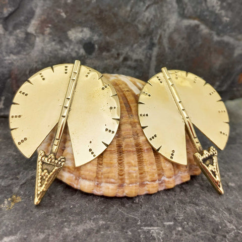 Large brass studs with an arrow design and large orb