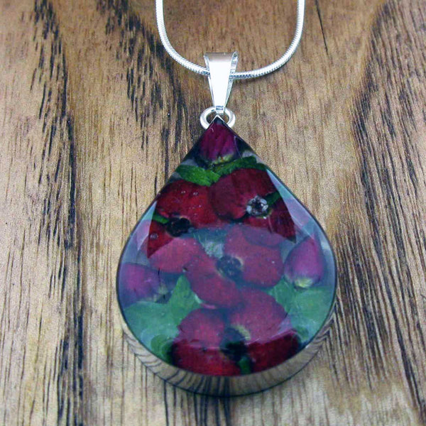 Silver pendant with real poppiesand rosebuds