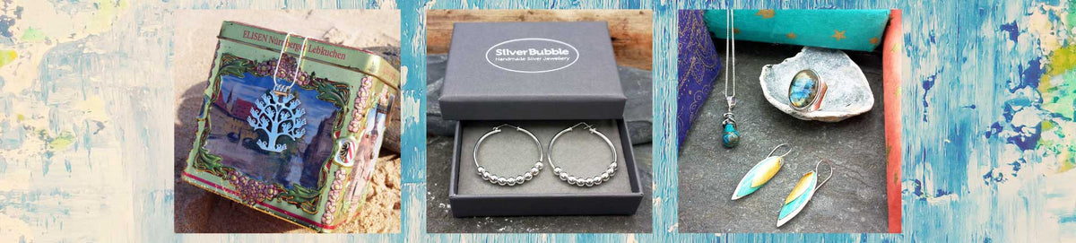 A three-panel collage showcasing inspiration for gift buying. Sterling silver unusual jewellery is in the 3 panels on a rustic blue wooden background. The left panel shows a decorative box with a blue and green illustration with a tree of life pendant.