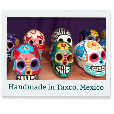 Colorful ceramic skulls with 'Handmade in Taxco, Mexico' text on a white background