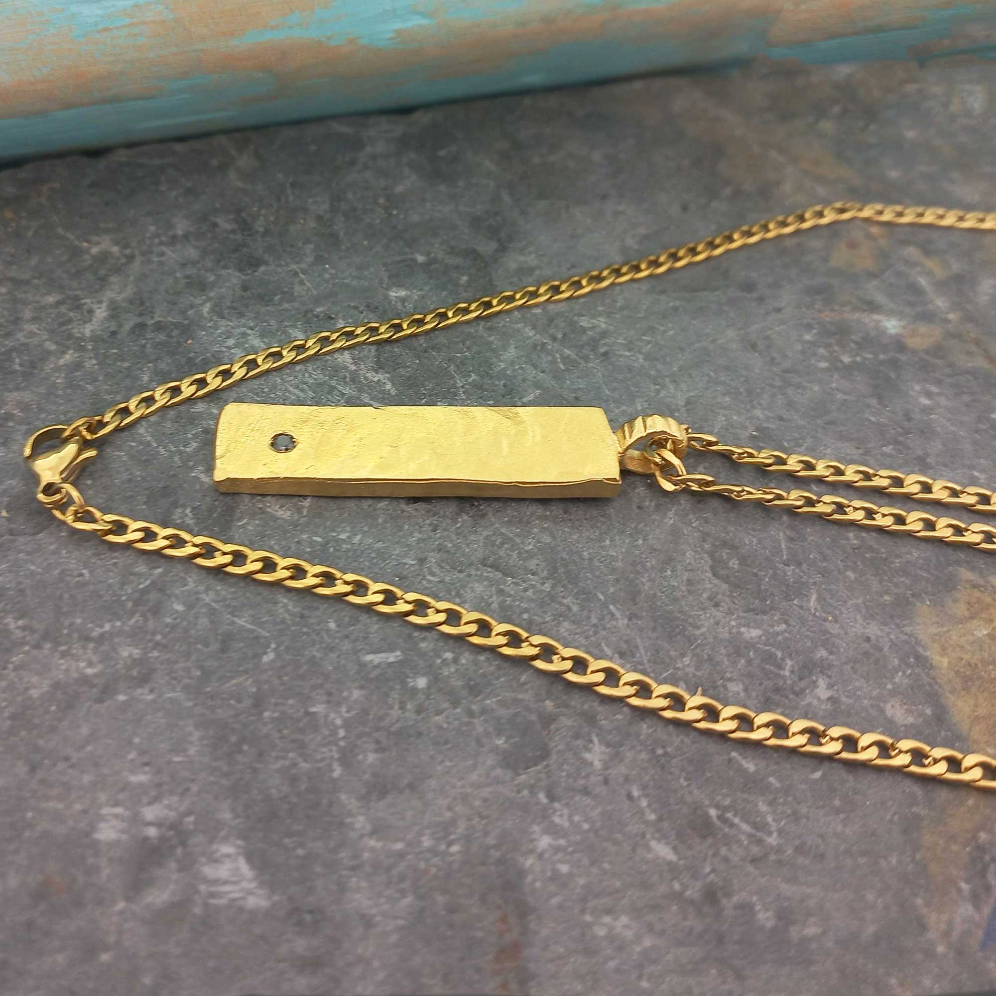 Gold plated chain and brass pendant with black glass cabochon necklace