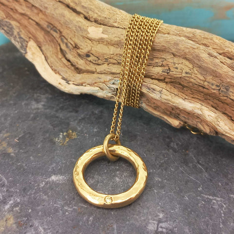 White glass cabochon on gold plated circle necklace