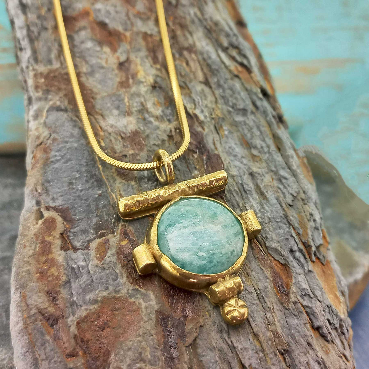 Brass gold hue artisanal necklace with Amazonite stone. Main image