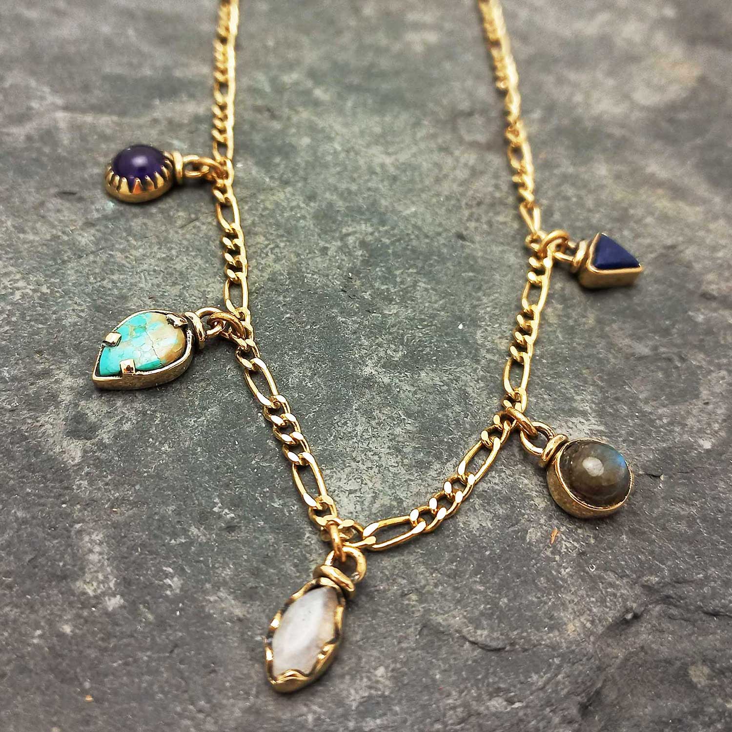 Gold coloured brass necklace with various semi-precious stone charms