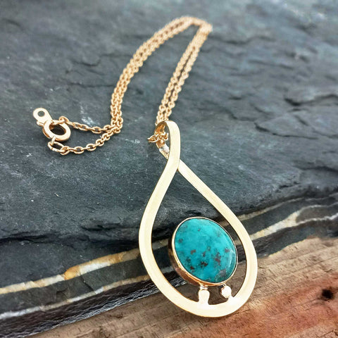 Unusual brass pendant with turquoise stone