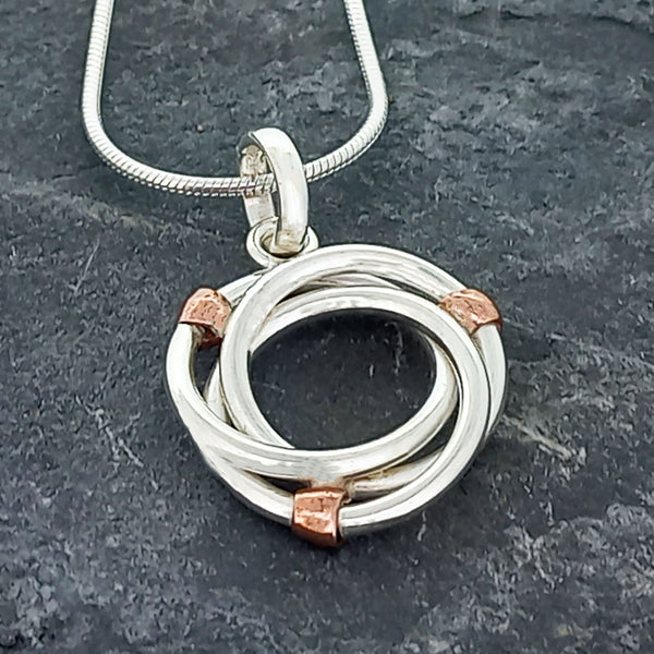 Silver circle with copper bead pendant