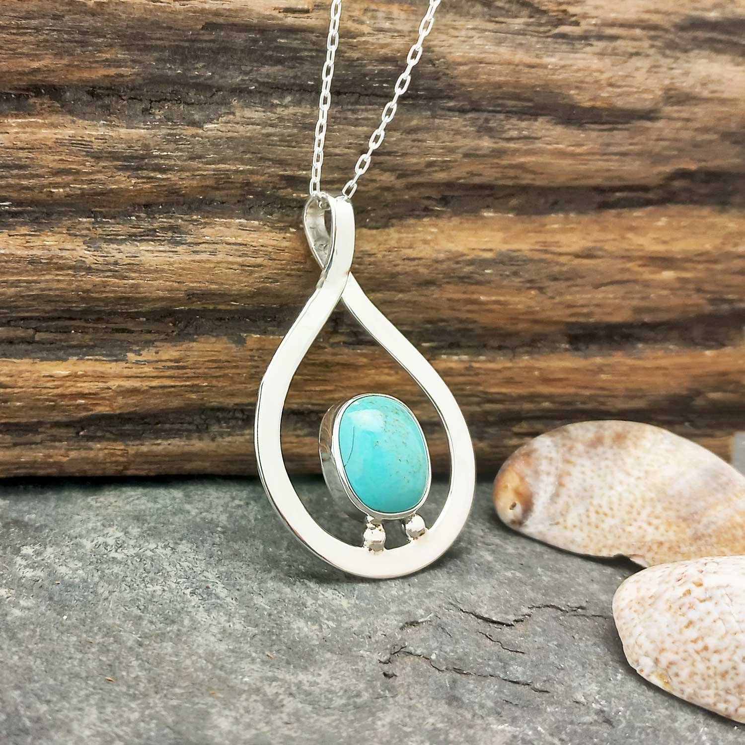 Artisan silver pendant with turquoise