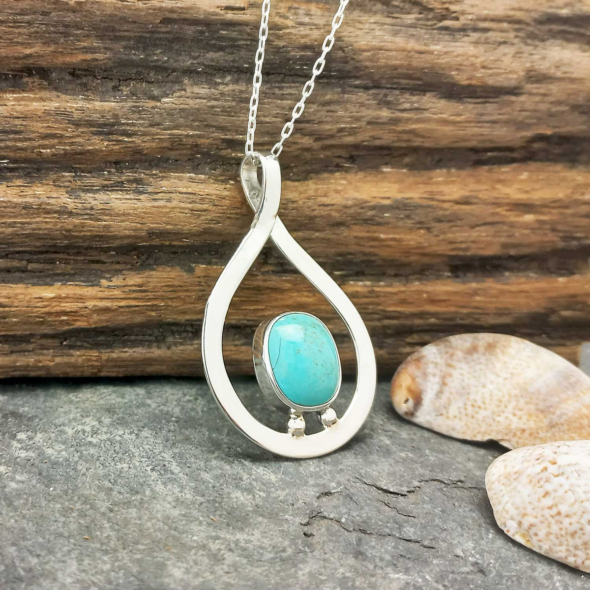 Artisan silver pendant with turquoise