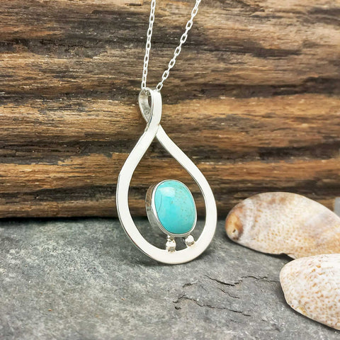 Artisan silver pendant with turquoise
