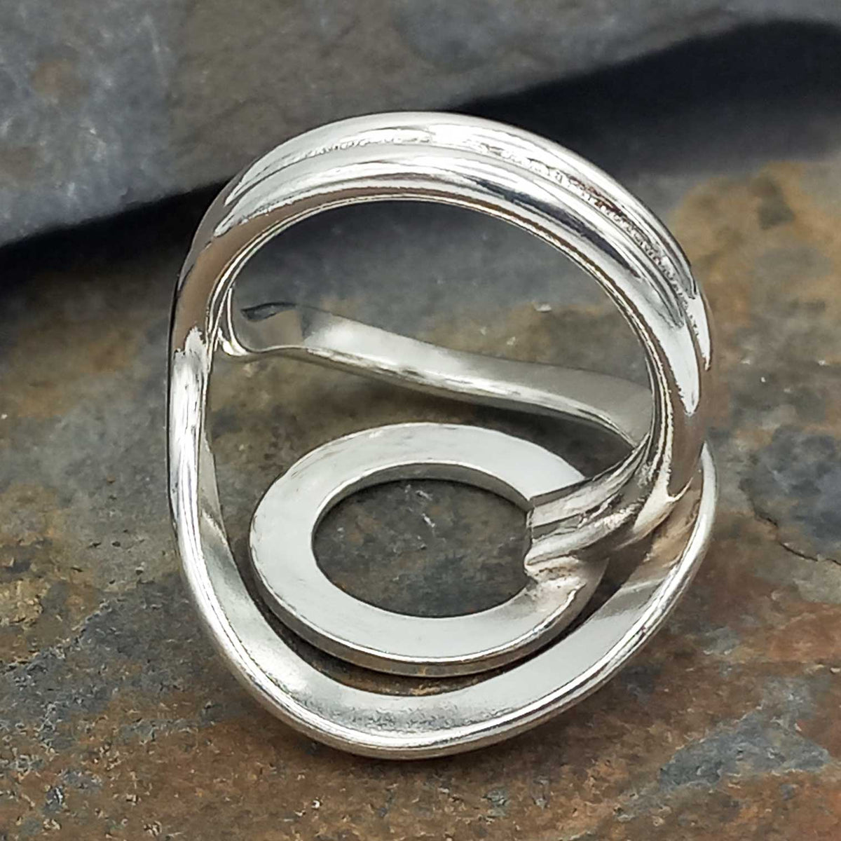 Silver ring on a stone surface