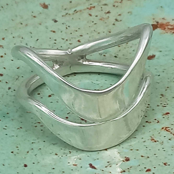 Silver ring on a textured green surface