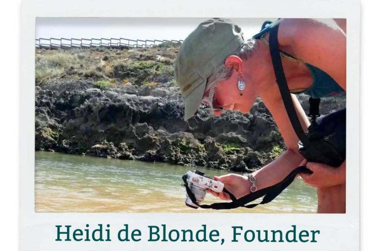 Image of Silver Bubble founder taking a photograph of silver jewellery at the beach