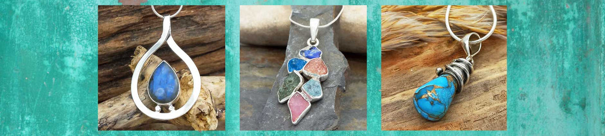 Three handmade sterling silver pendants with colourful gemstones, displayed on a rustic wood background with a teal textured border.