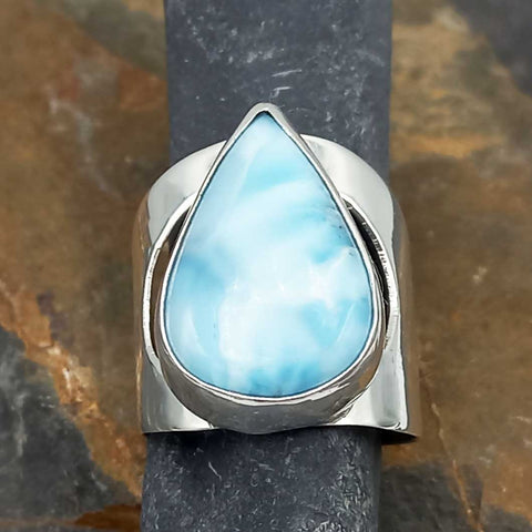 Silver ring with a Larimar stone on a dark background